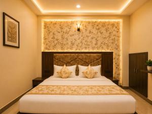 a bedroom with a large bed in a room at Hotel Crystal Blues in Mathura +13 photos