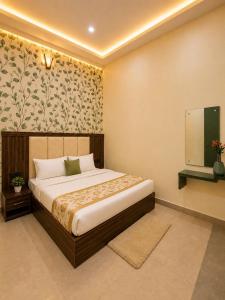 a bedroom with a large bed and a tv at Hotel Crystal Blues in Mathura