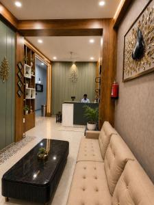 a living room with a couch and a table at Hotel Crystal Blues in Mathura