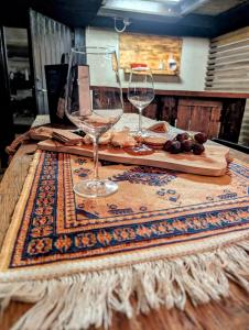 a table with two wine glasses and a laptop at Hindås stuga in Hindås