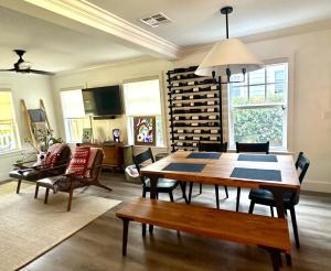 a dining room with a table and chairs and a wine cellar at Northwood Revival in West Palm Beach