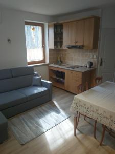 a living room with a couch and a table at Chata nad kúpaliskom in Kováčová