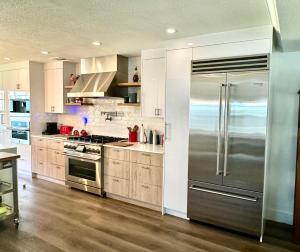 a large kitchen with a stainless steel refrigerator at Northwood Revival in West Palm Beach