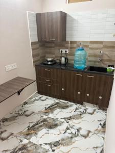 a kitchen with a sink and a counter with a rug at DRK Luxury Stays in Siruseri