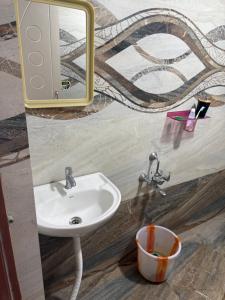 a bathroom with a sink and a mirror at DRK Luxury Stays in Siruseri +20 photos