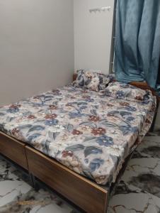 an unmade bed in a room with a bed frame at DRK Luxury Stays in Siruseri