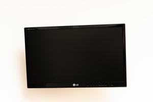a flat screen tv hanging on a wall at Casa Di Mare in Olympic Beach