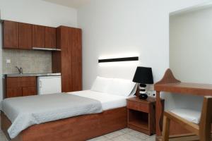 a small bedroom with a bed and a kitchen at Casa Di Mare in Olympic Beach