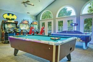 a game room with a pool table and many machines at Kingsgate Resort 3BR Apartment in Williamsburg +61 photos