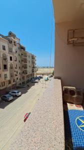 a balcony with a view of a parking lot at Ashraf Residential Complex in Luxor