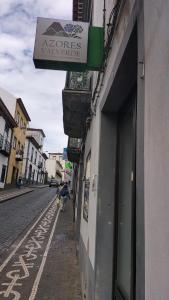 a sign on the side of a building on a street at Jomafreitas in Ponta Delgada
