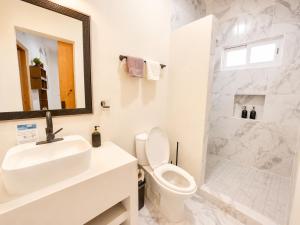 a bathroom with a sink and a toilet and a shower at Cabo Downtown Studios in Cabo San Lucas +121 photos