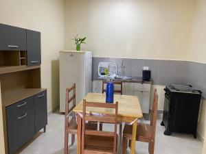 a kitchen with a table and chairs and a refrigerator at Maresia in Cacoal