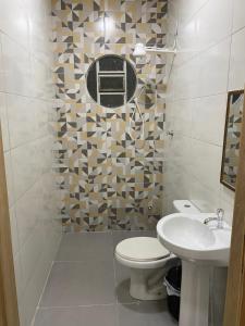a bathroom with a toilet and a sink at Maresia in Cacoal +43 photos