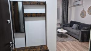a sliding glass door in a living room with a couch at Aqua Lux Apartman in Jagodina +7 photos