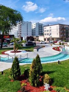 a park in a city with buildings at Aqua Lux Apartman in Jagodina