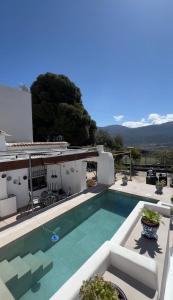a villa with a swimming pool and a house at Huerta La Niña Arenas in Órgiva