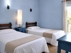 a hotel room with two beds and a window at Camino de Santiago Can Pau Costa Brava in Llança