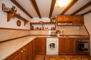 a kitchen with a washing machine and a sink at Вила Соколето in Sokolovtsi