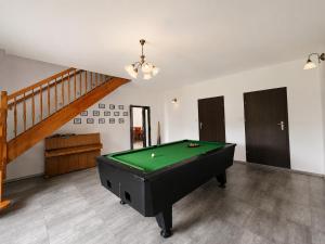 a pool table in a living room with a staircase at Agroturystyka Pod Dębem in Czyżówek