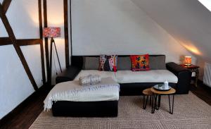 a living room with a couch and a table at Ferienhaus Rosengarten Mürlenbach in Mürlenbach