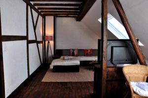 a attic room with two beds and a window at Ferienhaus Rosengarten Mürlenbach in Mürlenbach