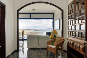 an open door to a room with a view of the ocean at Caleta Blue House - MacaronesiaHomes in Caleta de Caballo