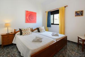 a bedroom with two beds and a window at Caleta Blue House - MacaronesiaHomes in Caleta de Caballo