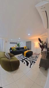 a living room with a couch and a zebra rug at Canaan Oasis in Pimpama