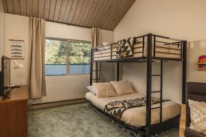 a bedroom with a bunk bed and a window at Alpine Charm By Alyeska Sleeps 6 in Girdwood