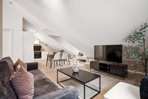 a living room with a couch and a table at 70 Degrees North City Apartments in Tromsø