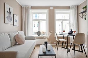 a living room with a couch and a table at 70 Degrees North City Apartments in Tromsø