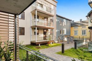 an apartment building with a balcony and a courtyard at 70 Degrees North City Apartments in Tromsø