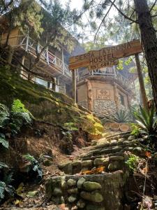 a model of a house with a sign in front of it at Sierra Tayrona hostel in El Zaino +68 photos