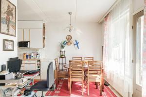 a kitchen and dining room with a table and chairs at Peace & Harmony in Espoo