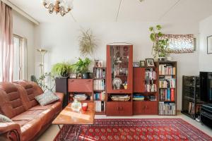 a living room with a couch and a book shelf at Peace & Harmony in Espoo