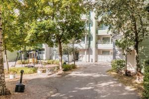 a park with a bench and a playground in front of a building at Peace & Harmony in Espoo