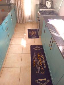 a kitchen with two signs on the floor in a kitchen at Laneens Apartments in Eldoret +2 photos