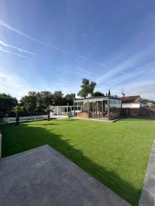 a large green yard with a glass house at La jaima in Santa Ceclina