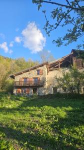 an old stone house in the middle of a field at Chalet coeur d'alpage La Plagne Les Arcs in La Plagne Tarentaise