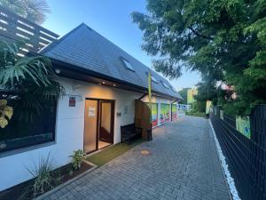 a small white building with a black roof at Kampenhout appartement met terras en 4 slaap kamers in Kampenhout
