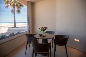 a dining room with a table and chairs and a window at Terradamare Suites in Monopoli