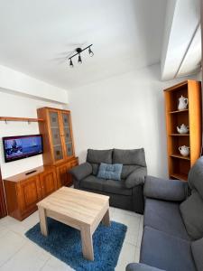 a living room with a couch and a coffee table at Recuncho de Corme, a 100 metros de la playa in Corme-Puerto