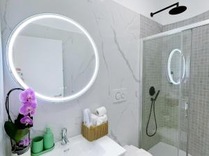 a bathroom with a sink and a mirror and a shower at Ciao Termini in Rome