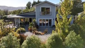 a house with a garden in front of it at The Artist's House Wanaka in Luggate