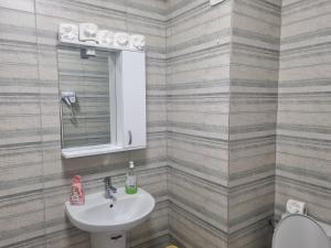 a bathroom with a sink and a toilet at GOLDEN APARTMENT- Militari Residence Bucharest in Dudu +15 photos