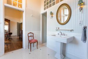 a bathroom with a sink and a mirror on the wall at Le Logis d'Equilly in Équilly +88 photos
