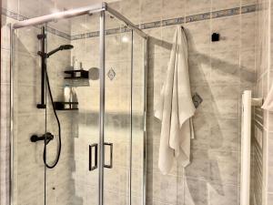 a bathroom with a shower with a towel hanging on it at Chalet San Primo in Castiglione dʼIntelvi