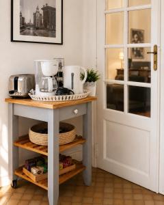 a kitchen with a table with a blender on it at Appartement calme et spacieux - Garage vélo in Saint-Quentin +10 photos
