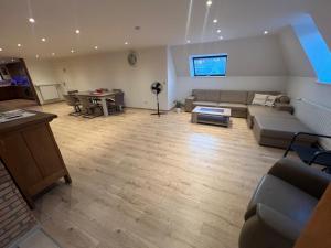 a living room with a couch and a table at Kampenhout appartement met terras en 4 slaap kamers in Kampenhout
